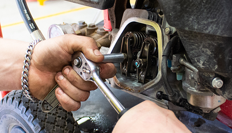 Man using tools to service a pressure cleaner