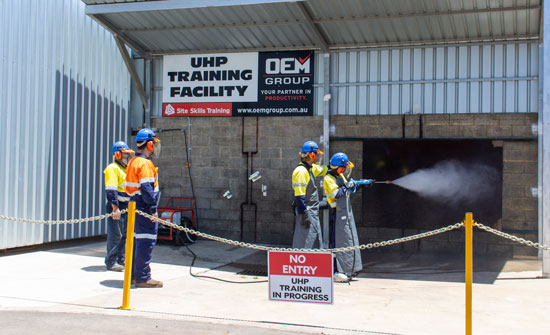 Ultra High Pressure Cleaner Training in Front of the Sign at OEM Group in Ascot