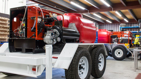 Two pressure cleaner trailers being built in a workshop