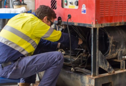 OEM Group service technician working on a SPITWATER pressure cleaner