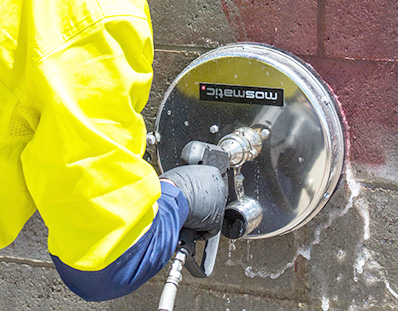 High Pressure Mosmatic Graffiti Cleaner Cleaning Paint off a Wall.