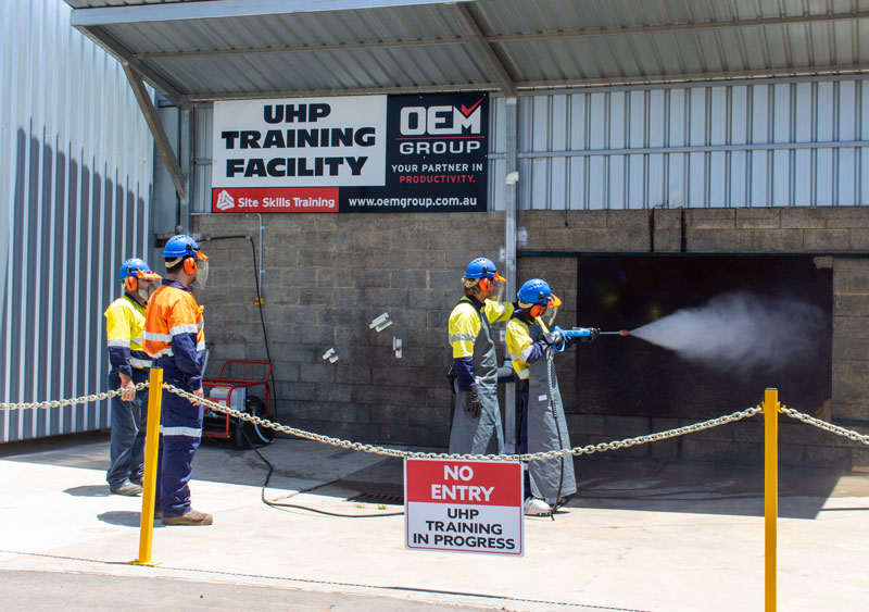 Ultra High Pressure Cleaner Training in Front of the Sign at OEM Group in Ascot