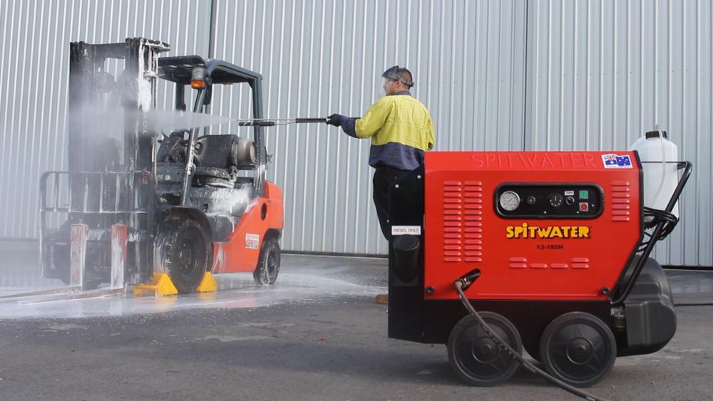 pressure cleaning forklift with pressure cleaner in foreground