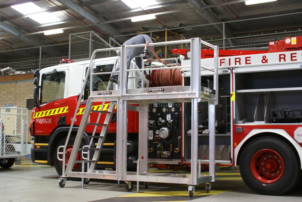 custom steprite platform next to fire truck