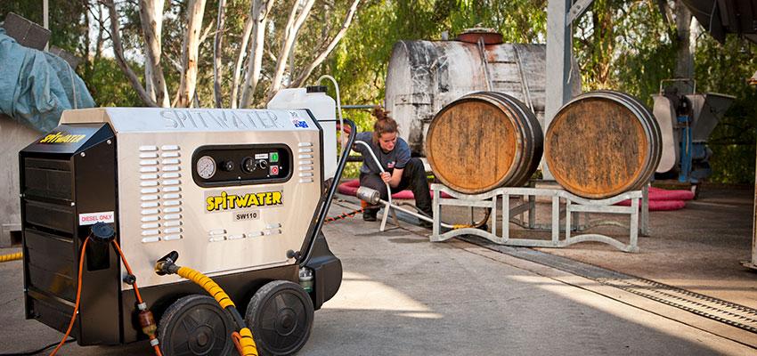 Spitwater electric pressure cleaner cleaning wine barrels in a winery