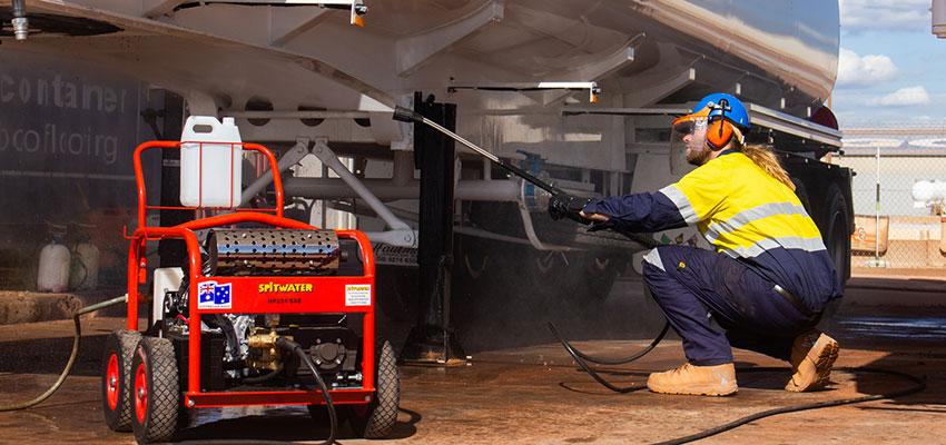 Spitwater petrol pressure cleaner cleaning a truck on red dirt