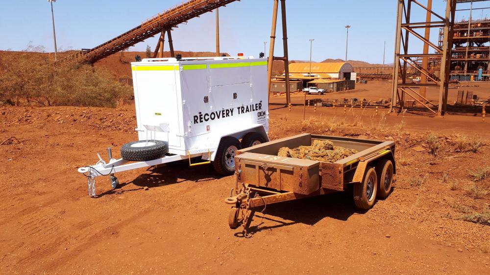 OEM Groups recovery trailer next to a normal trailer with the tow rope in it, on a minesite in Western Australia.