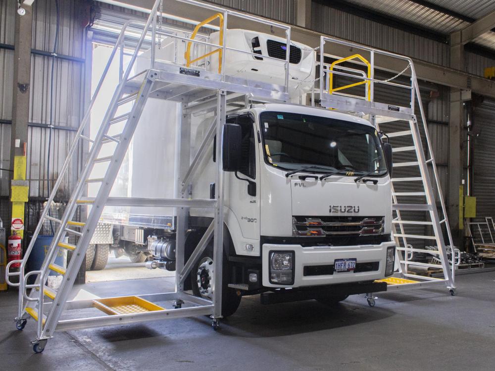 two platforms pushed against refrigeration truck in workshop