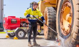 Spitwater Diesel Pressure Cleaner Trailer Cleaning a CAT Truck Tyre