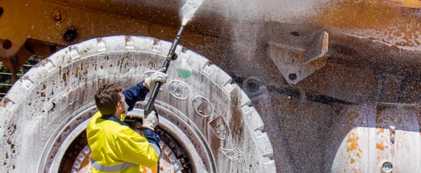Operator using a SPITWATER Pressure Cleaning Foaming a CAT Truck