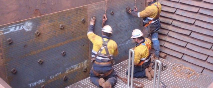 workers on a custom platform in a chute