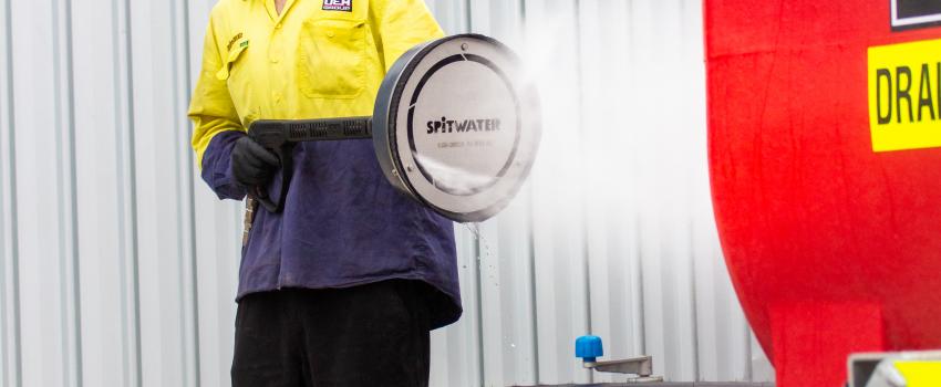 man using hydrofogger to clean