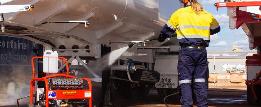 Pressure cleaning a truck with a Spitwater pressure cleaner in the red dirt