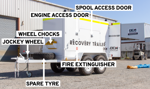 Heavy vehicle recovery trailer in yard labelled