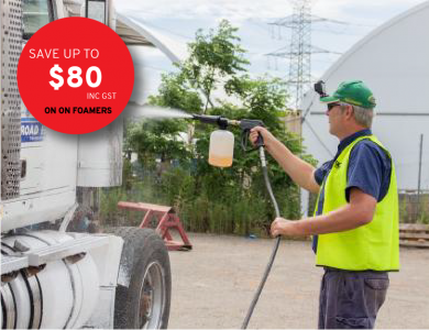 High pressure spray of chemical foam onto a truck in a truck yard with promo savings