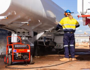 Pressure cleaning a truck with a Spitwater pressure cleaner in the red dirt